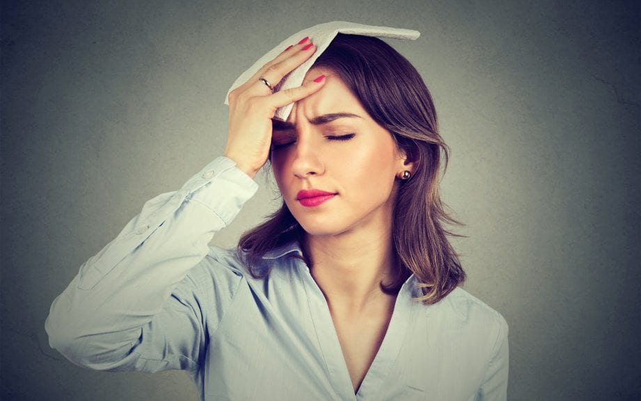 MAIN Woman wiping sweat from forehead 920x575 1